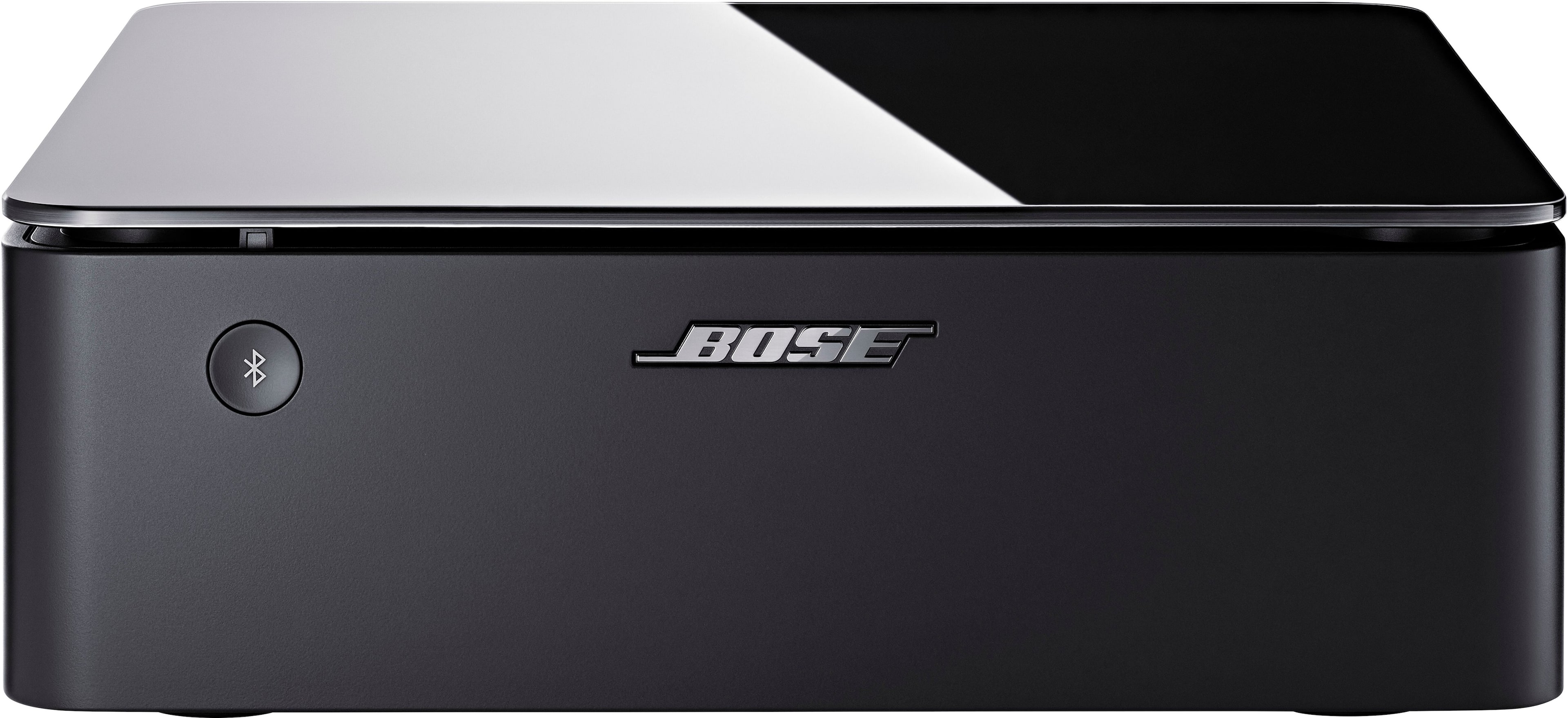 Bose Music Amplifier connected to speakers in a modern living room